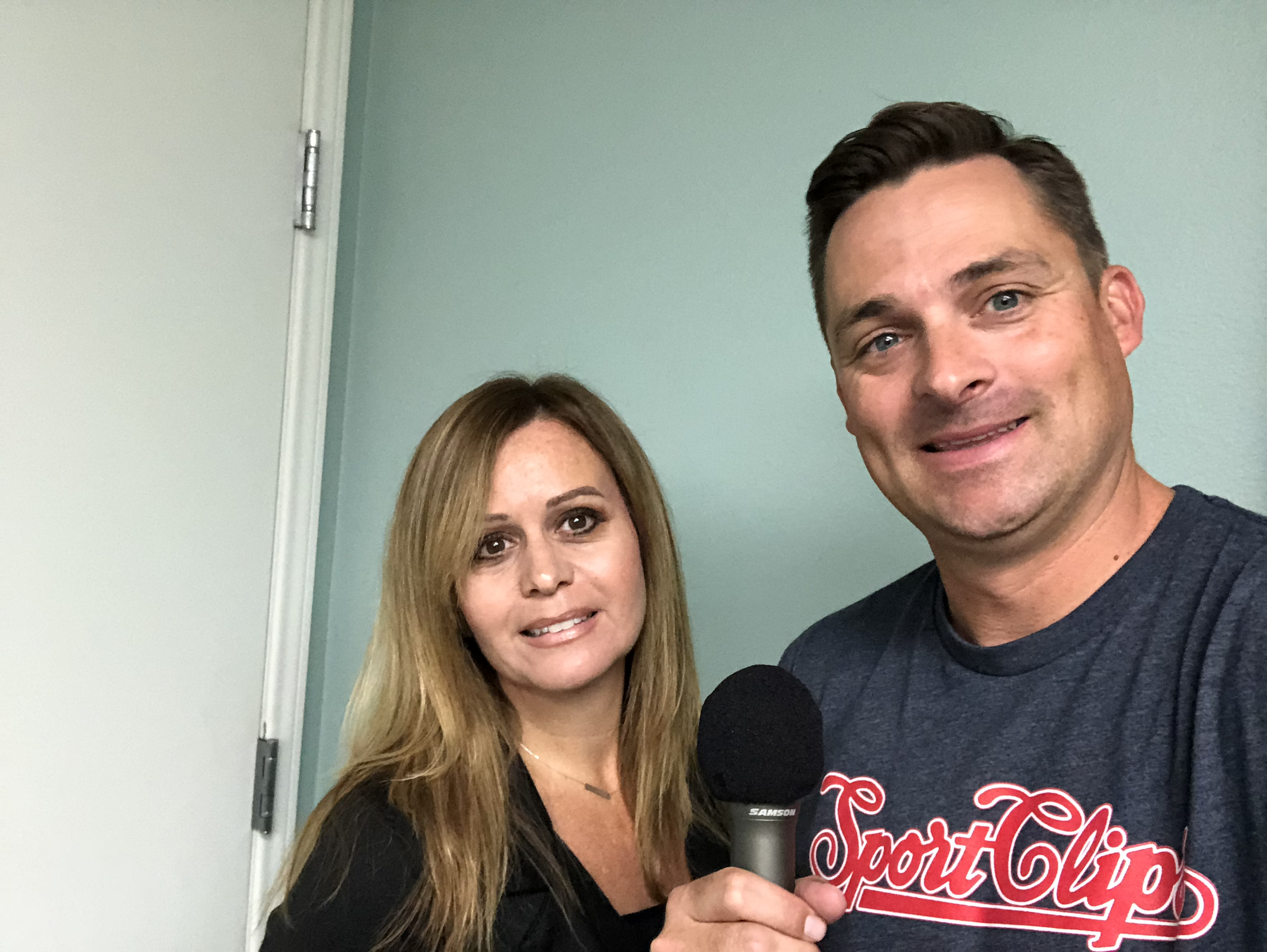 Jennifer Justis and Chad Jordan holding a microphone